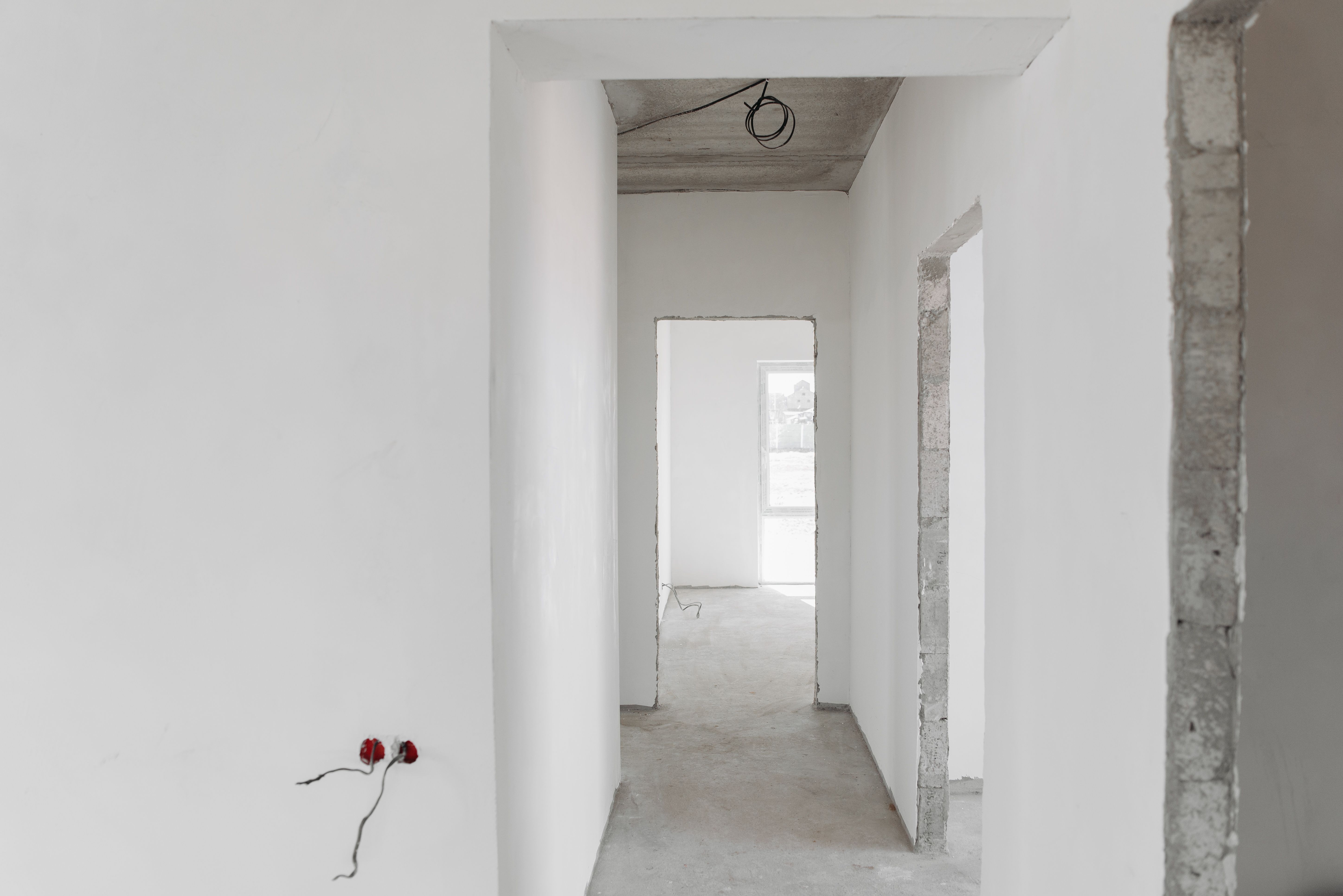 Partial strip-out revealing brickwork with tools and dust protection on floor